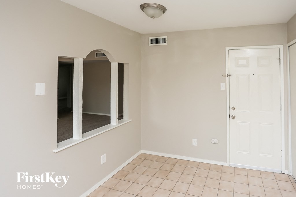 a empty room with a mirror and a door