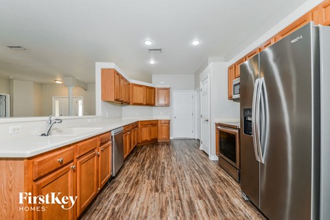 the kitchen is clean and ready to use with stainless steel appliances