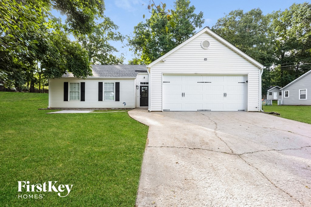 A white house with a garage is for sale by FirstKey Homes.
