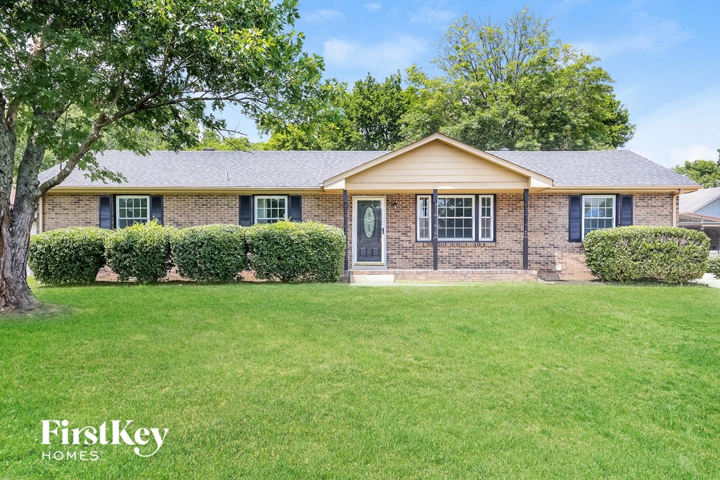 A house with a lawn in front of it.