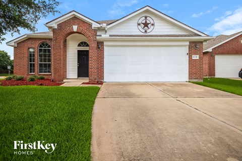 a house with a driveway and a white garage door
