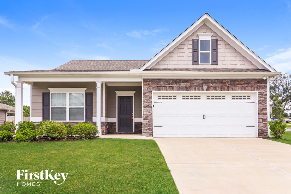 a house with a white garage door and a lawn