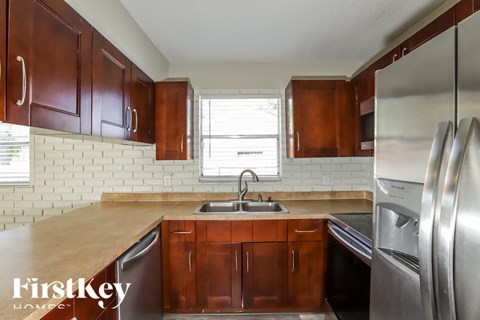 A kitchen with wooden cabinets and stainless steel appliances.