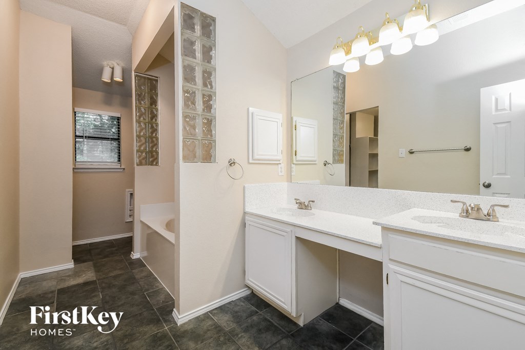 a bathroom with a sink and a toilet and a mirror