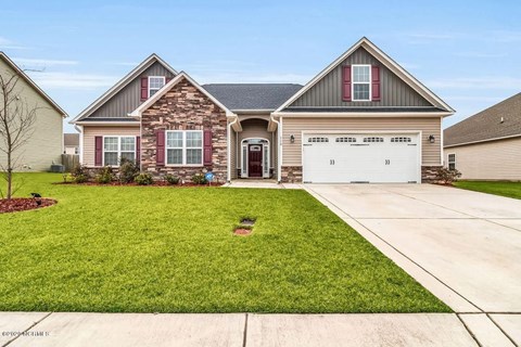 A house with a red brick facade and a white garage door.