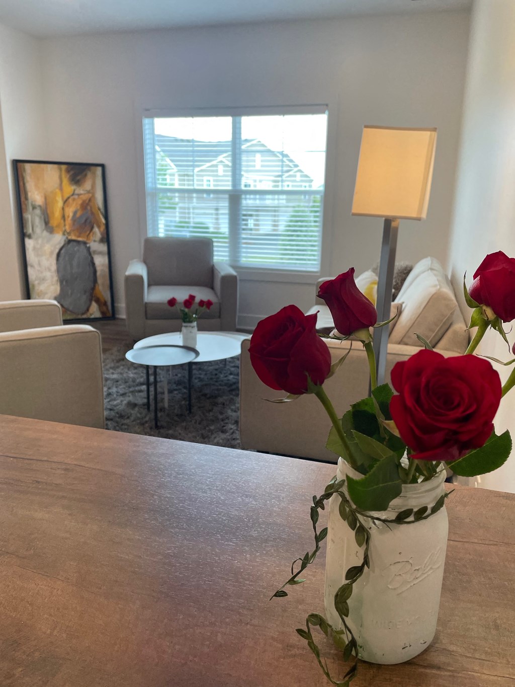 a vase with roses on a table in a living room