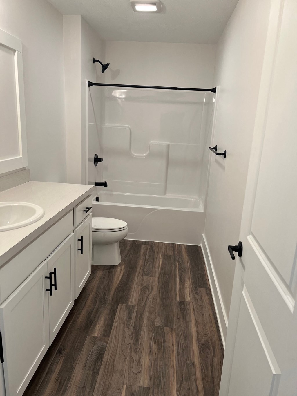 a bathroom with a shower and a sink and a toilet