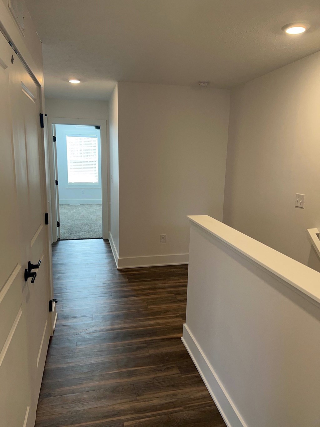 a view of the hallway from the bottom of the stairs looking into the living room