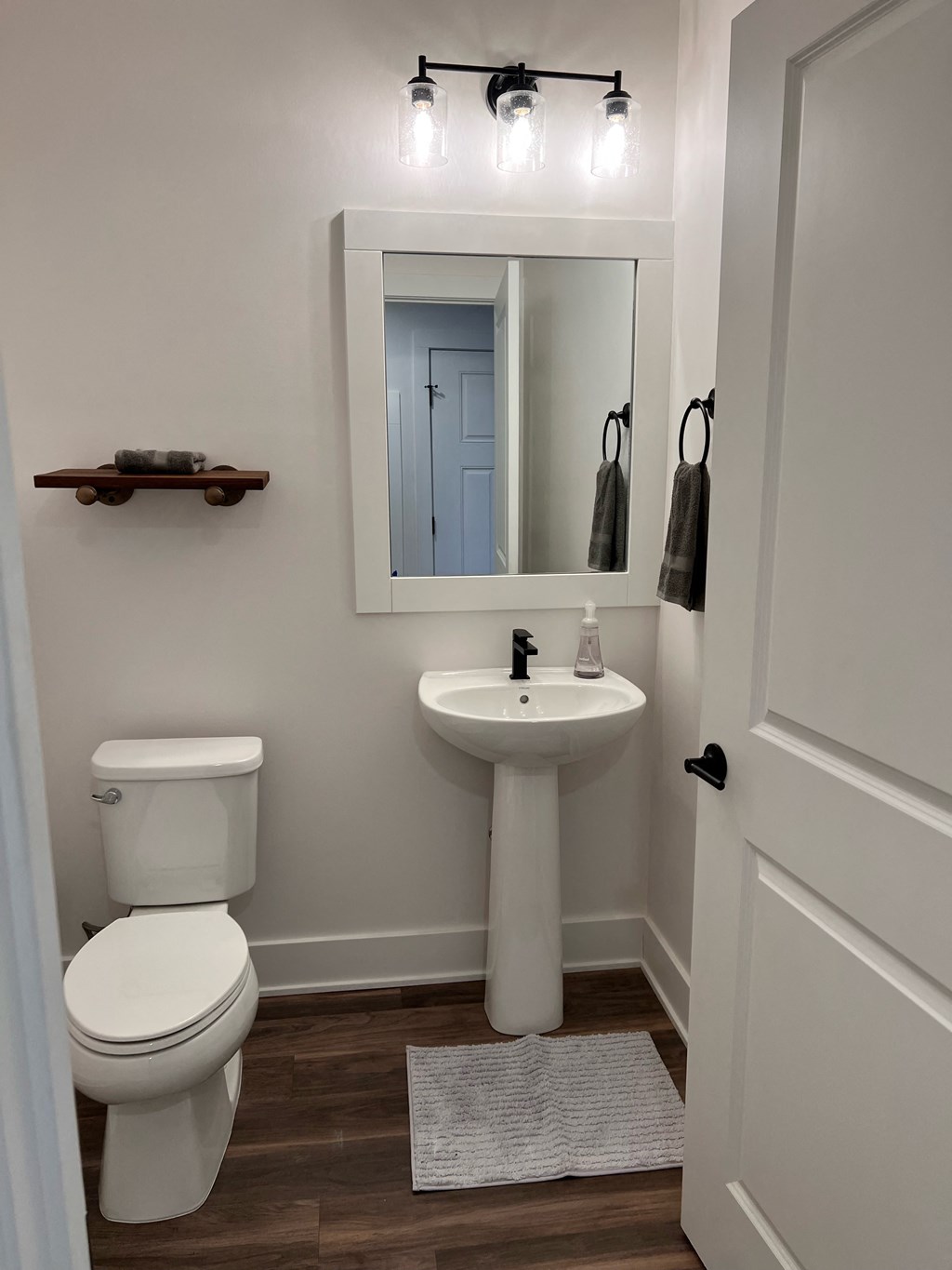 a small bathroom with a sink toilet and mirror