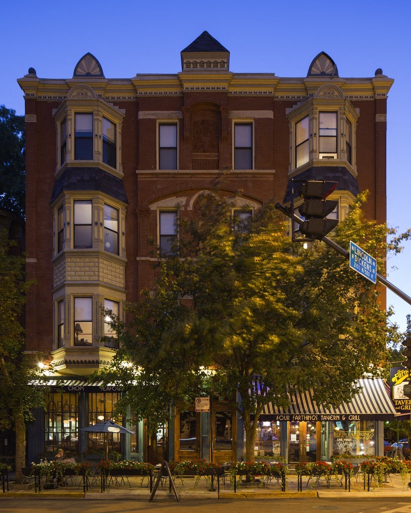 a building on the corner of a street at night