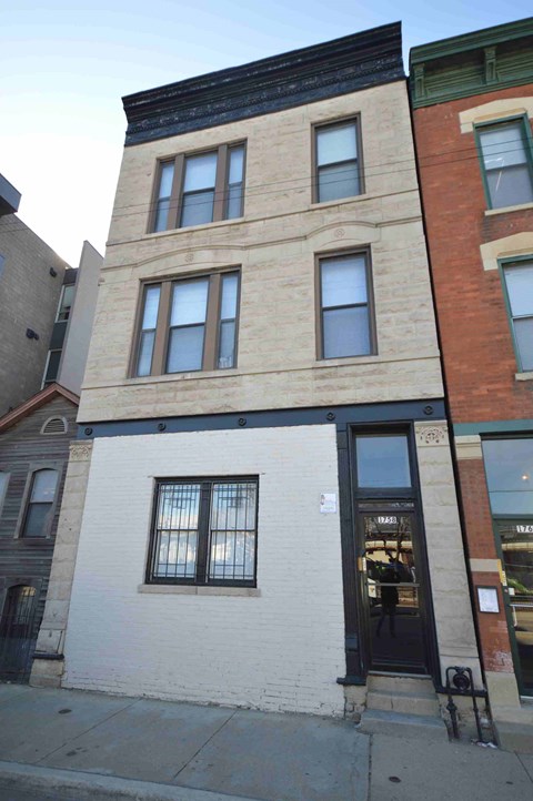 a building with a door and windows on a street