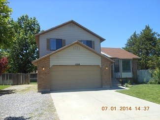 A house with a garage and a driveway is shown.