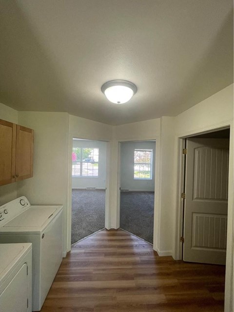 an empty kitchen with a door to a living room