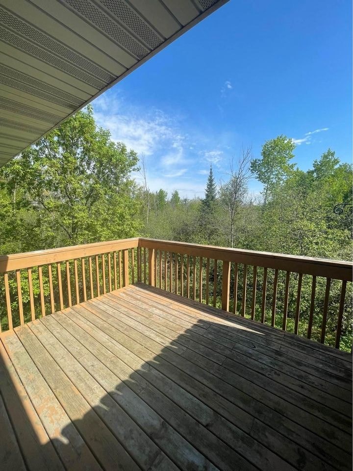the view from the deck of a cabin with trees