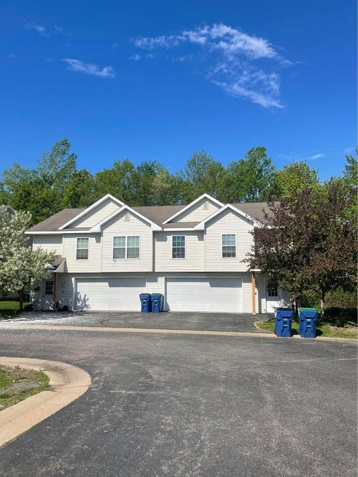 a white house with a street in front of it