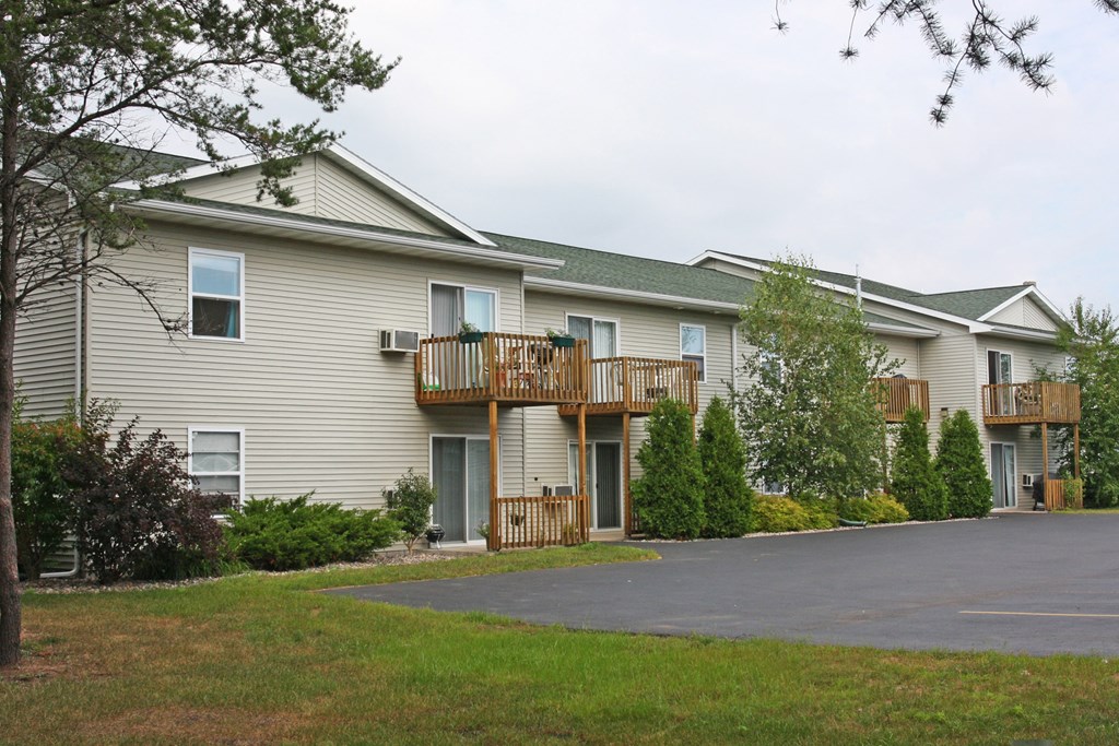 the exterior of a home with a paved driveway and a deck