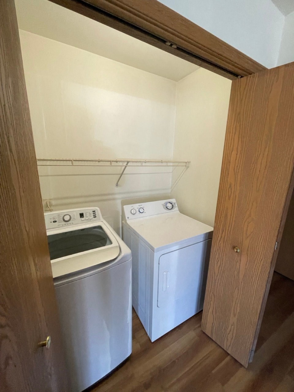 an empty laundry room with a washer and a dryer