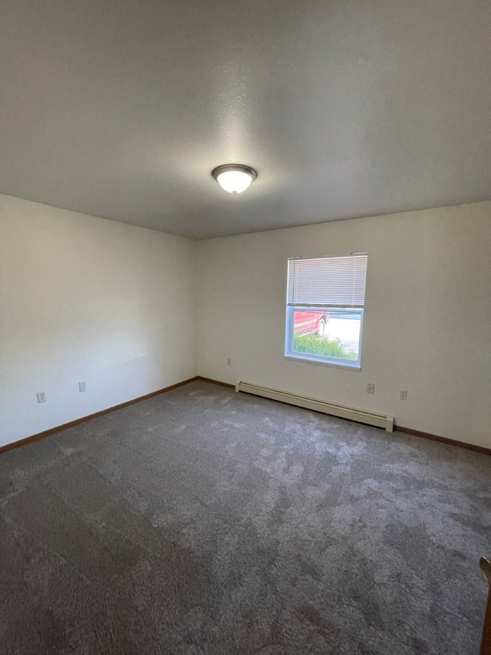 the living room of an empty house with a window