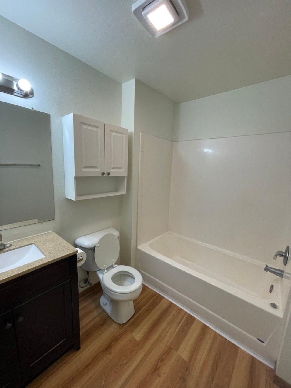 a bathroom with a toilet and a tub and a sink