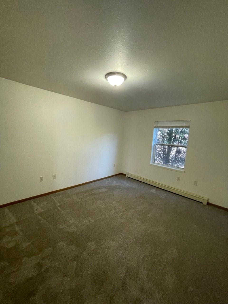 the living room of an empty house with a window