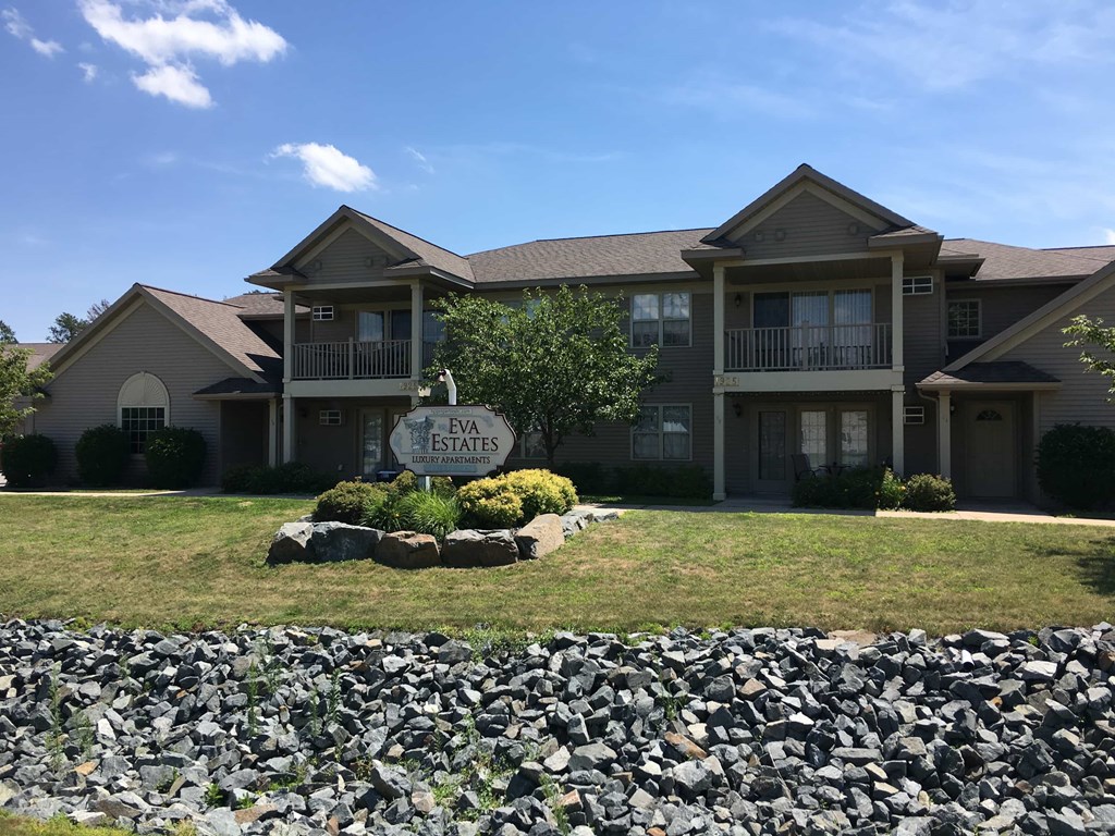 a large house with a sign in front of it