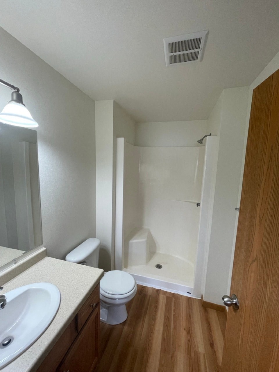 a bathroom with a toilet and a sink and a shower