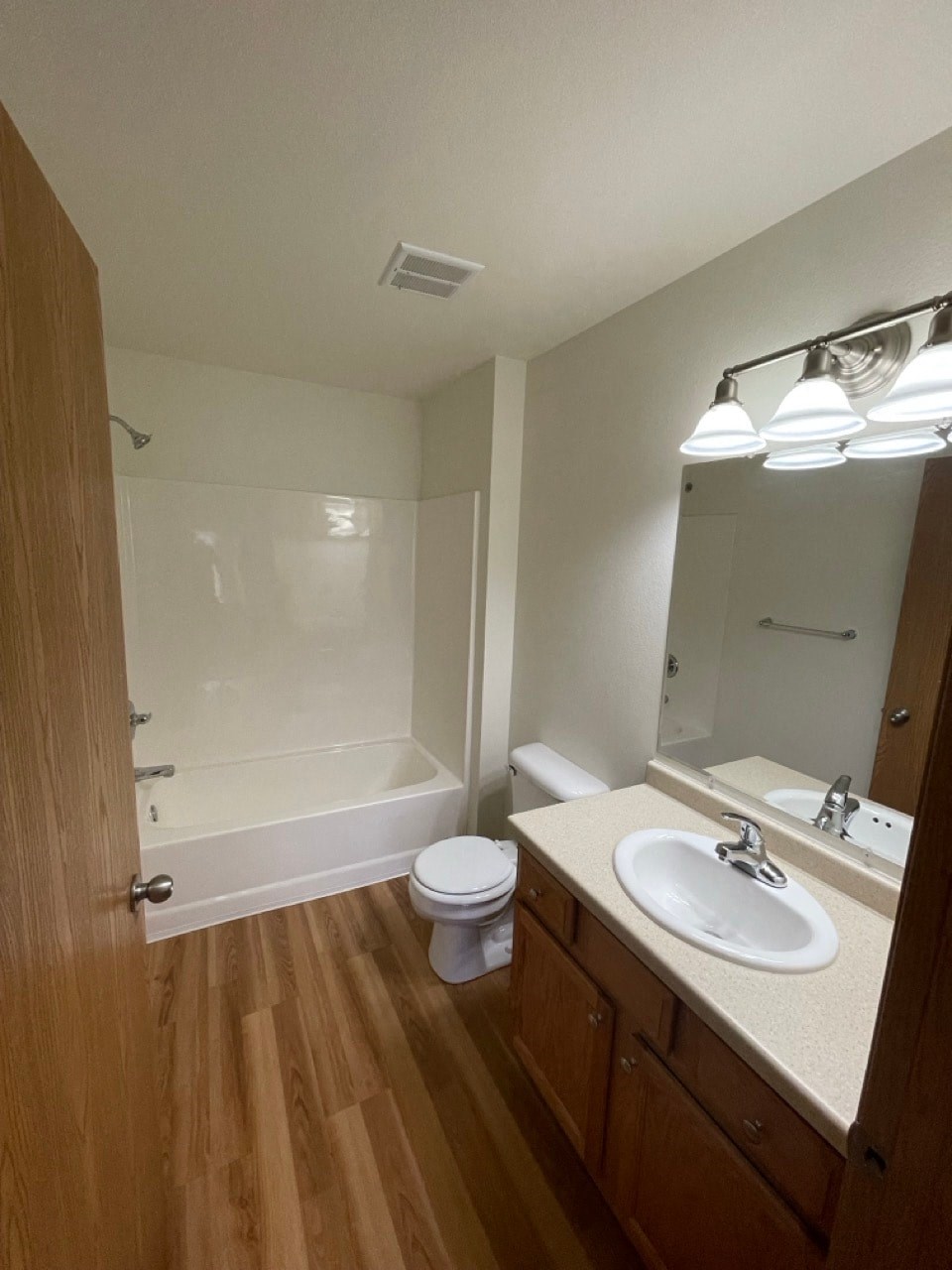 an empty bathroom with a sink toilet and shower