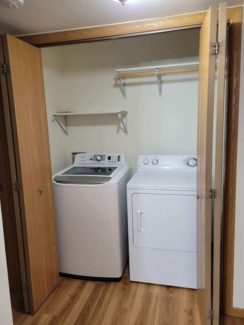 A small laundry room with a washer and dryer.