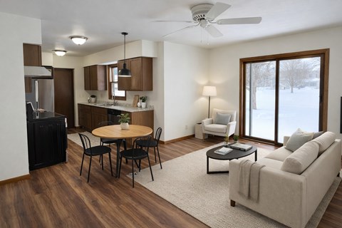 A modern living room with a dining table and chairs.