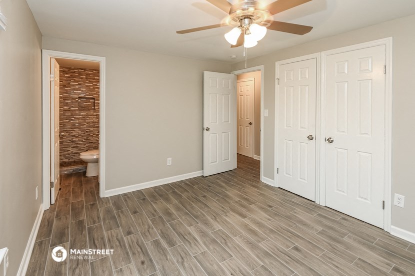 the living room of a new home with a ceiling fan