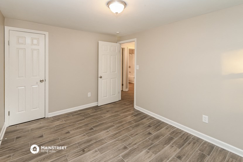 the spacious living room with vinyl flooring and white doors