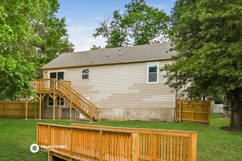 the back of a house with a wooden deck