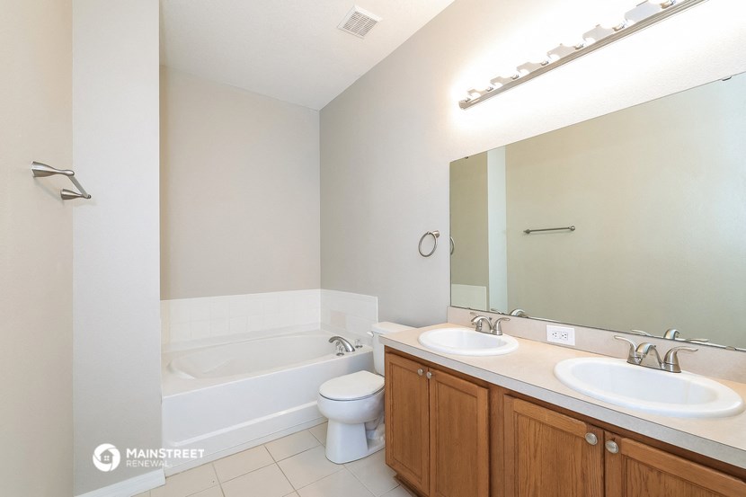 a bathroom with two sinks and a tub and a toilet