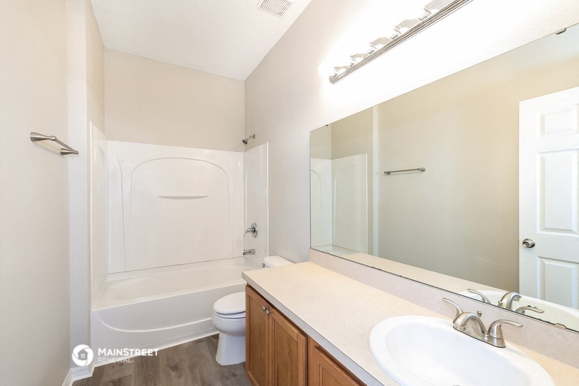 a bathroom with a sink and a toilet and a shower