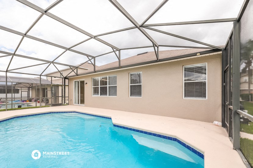 a swimming pool is under a canopy next to a house
