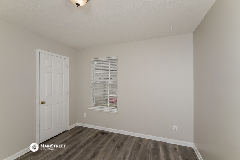 the interior of an empty room with a door and a window