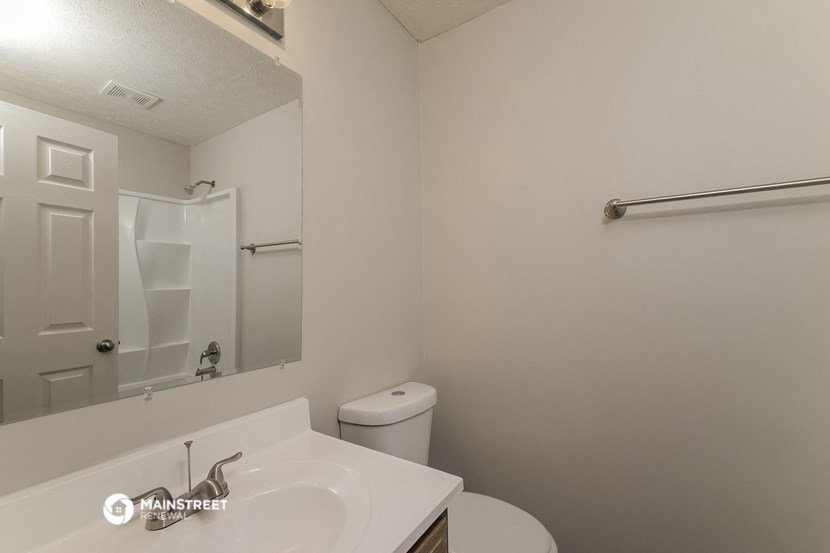 a bathroom with a sink and a toilet and a shower