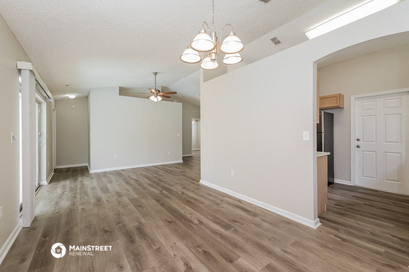 the living room and dining room of an apartment
