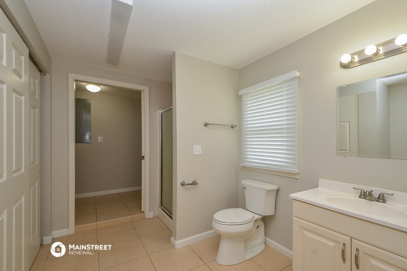 a bathroom with a toilet and a sink and a shower