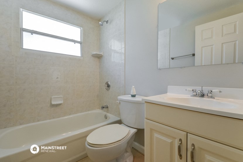 a bathroom with a toilet and a sink and a bath tub