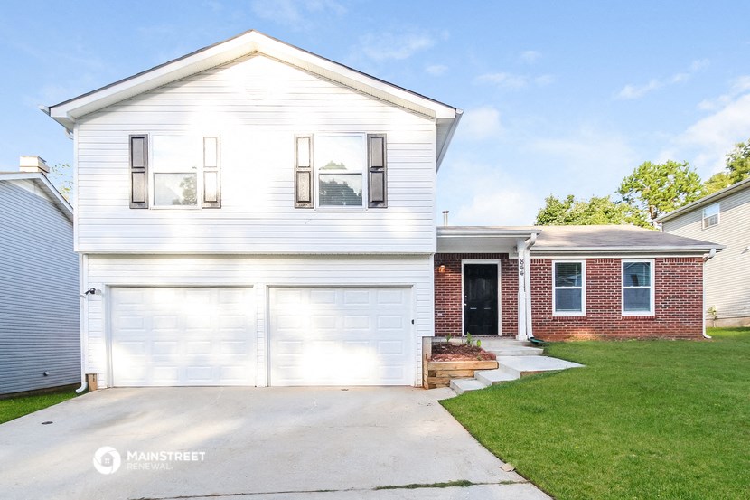 a white house with a white garage door