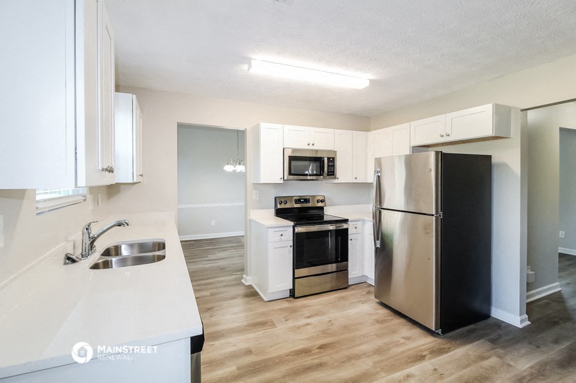 a kitchen with stainless steel appliances and white cabinets