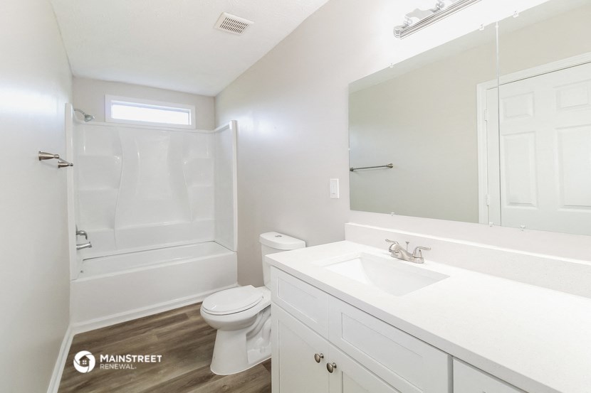 a bathroom with a white sink and a shower and a toilet