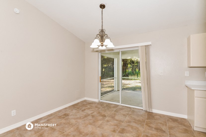 a living room with a sliding glass door to a patio