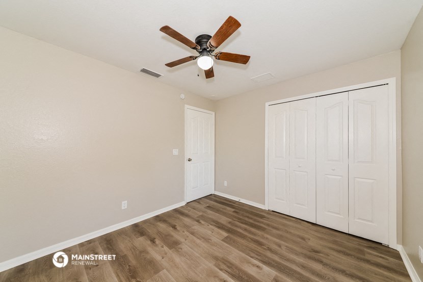 the living room of our studio apartment atrium with ceiling fan and closet