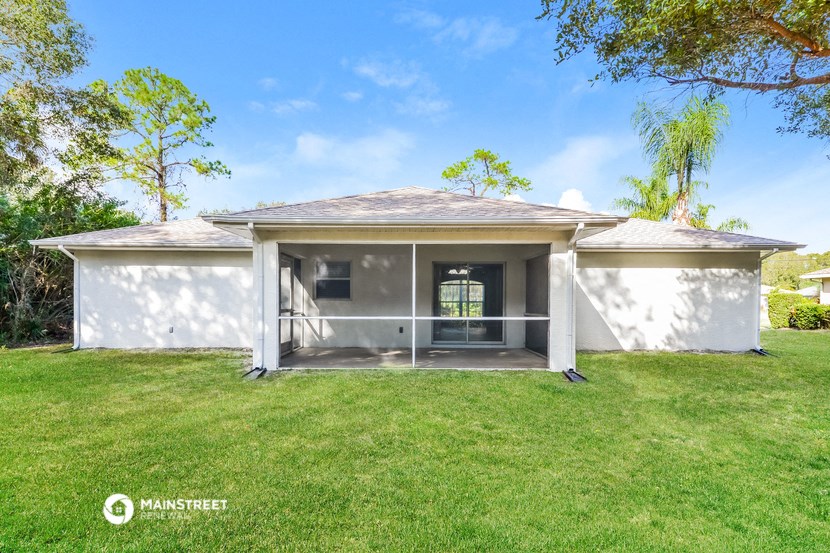 a white house with a lawn and a garage door