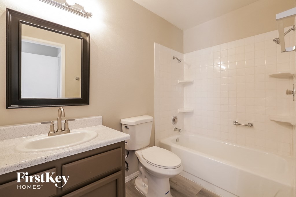 a bathroom with a sink toilet and a bath tub