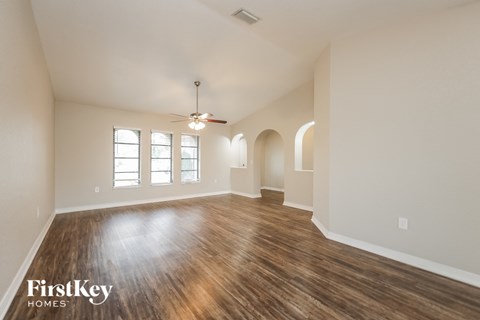 the living room and dining room of an empty house