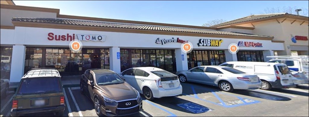 A Sushi Tomo restaurant is located in a strip mall with Subway and Wendy's.
