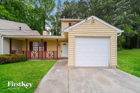 A house with a garage door is for sale by FirstKey Homes.